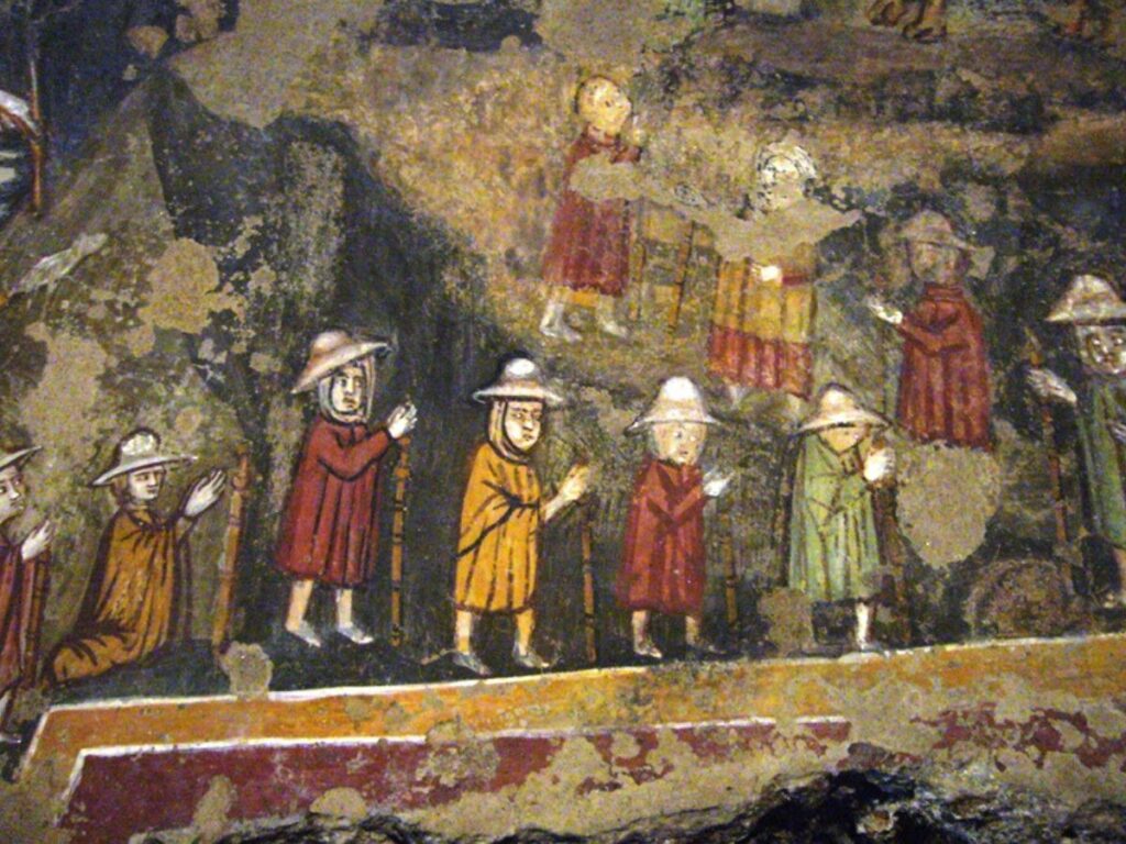 Pellegrini medievali lungo la via Francigena, immagine che racconta il turismo religioso in Puglia